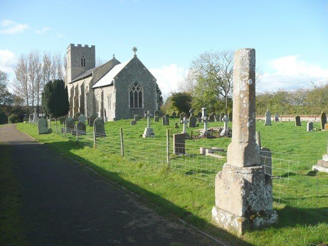 St Andrew's Church and cross, Field Dalling The tower is out of line with the nave, perhaps due to the rebuilding of the nave at some time. There is an elaborate cross at the top of the chancel gable. The cross in the foreground might have had an X-shaped head, as this motif occurs on the font.