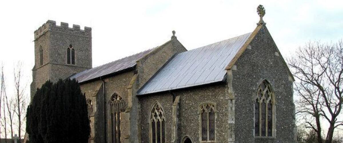 A stone church with a tower and arched windows.