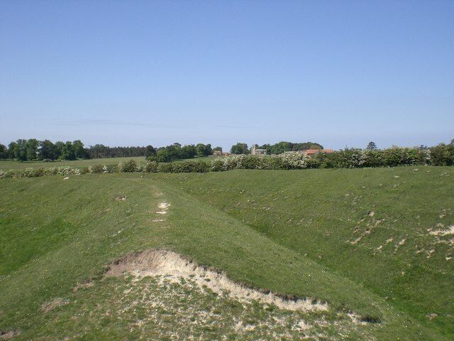 Outer wall and ditch, Warham Camp St Mary Magdelene's, Warham on the horizon with Church Farm to its left