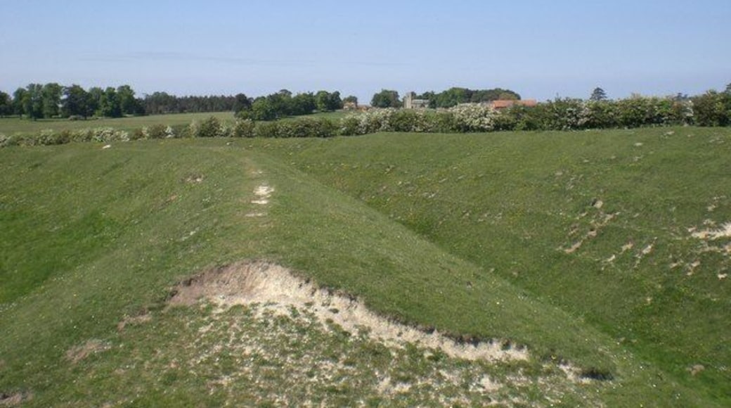Outer wall and ditch, Warham Camp St Mary Magdelene's, Warham on the horizon with Church Farm to its left