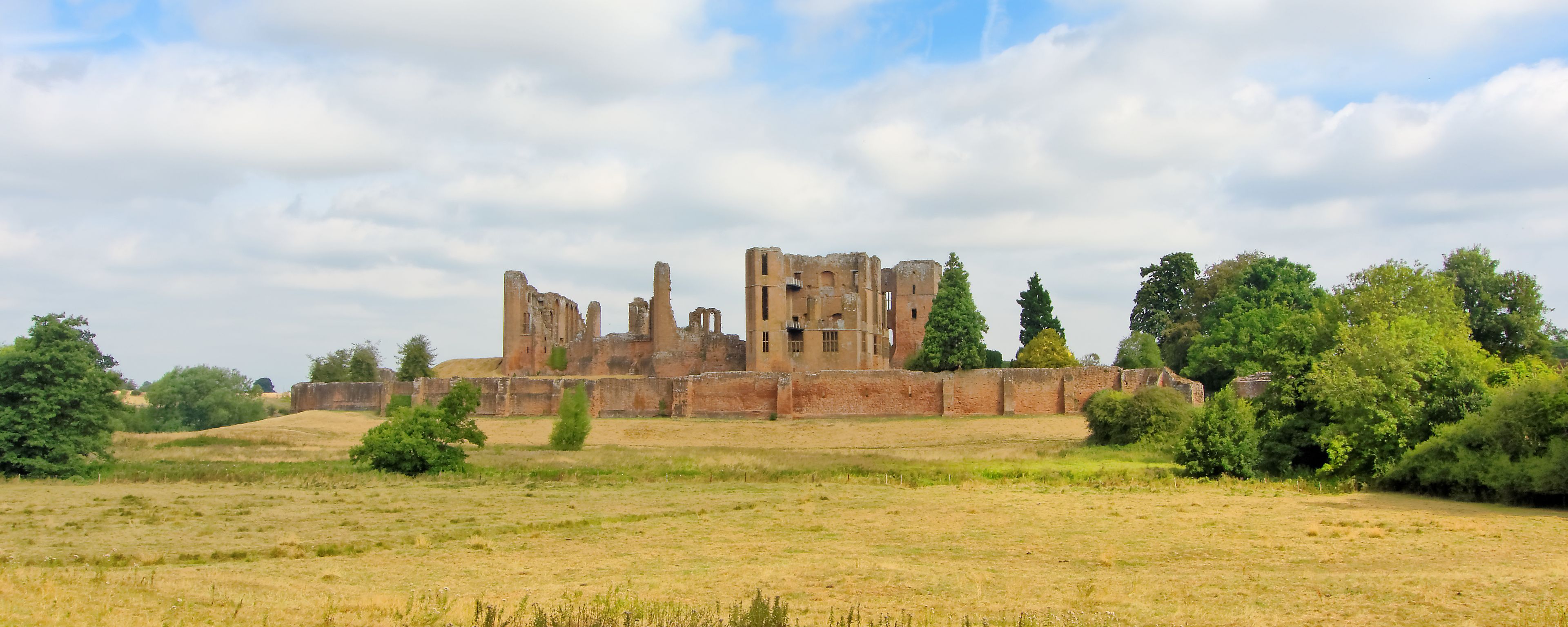 A panorama of the Kenilworth castle standing on a low hill, which was located in the heart of a 1,600 hectare park and is surrounded by a large artificial lake.