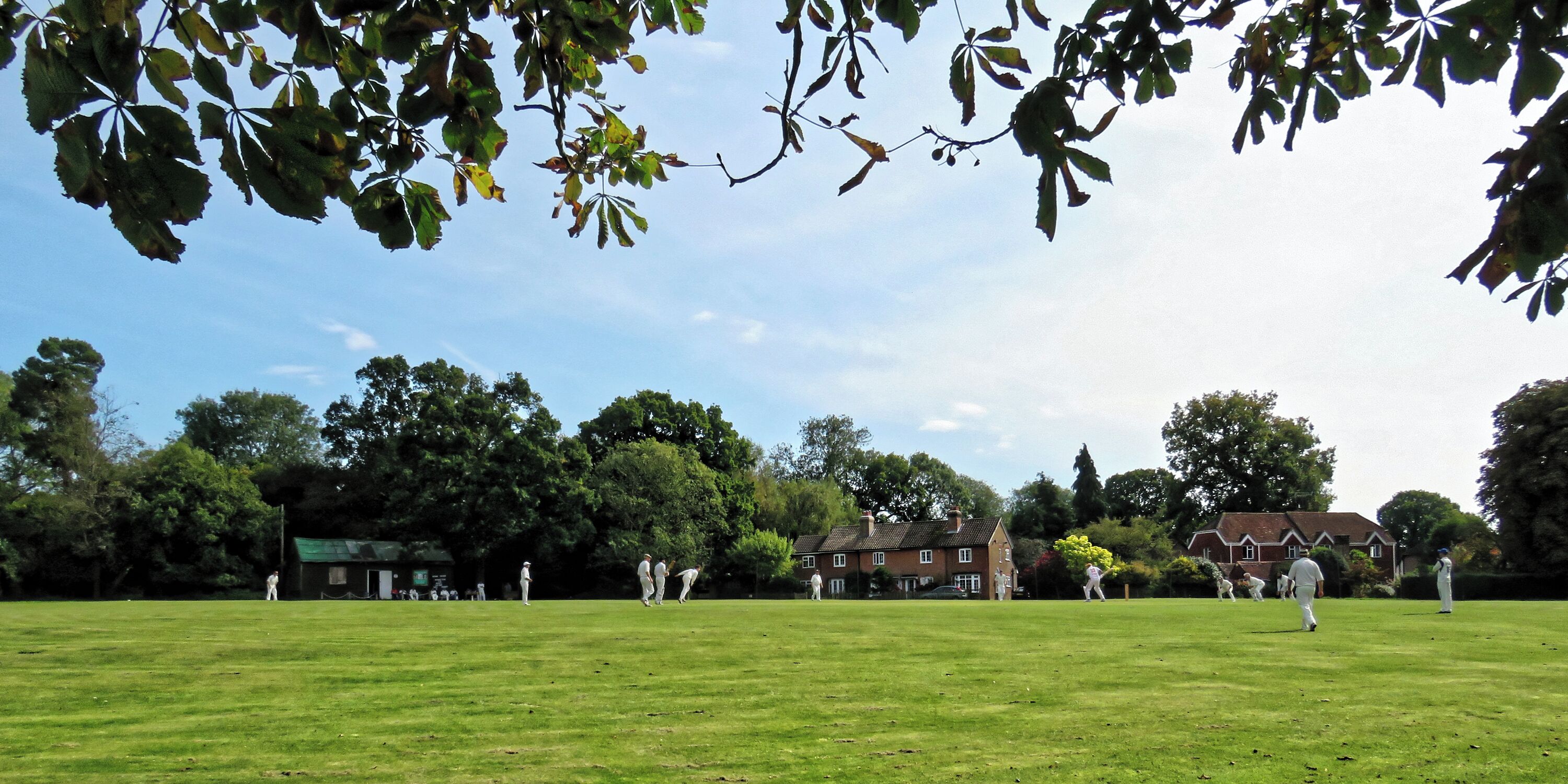 A public friendly Sunday cricket match between Nuthurst Cricket Club (which represents Nuthurst parish), and the East Dulwich, Middlesex-based Royal Challengers (batting) on the village green cricket ground at Mannings Heath in West Sussex, England. Camera: Canon PowerShot SX60 HS Software: File lens-corrected, optimized, perhaps cropped, with DxO OpticsPro 11 Elite, and likely further optimized with Adobe Photoshop CS2.