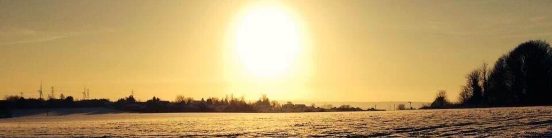 A late afternoon view over snow covered fields