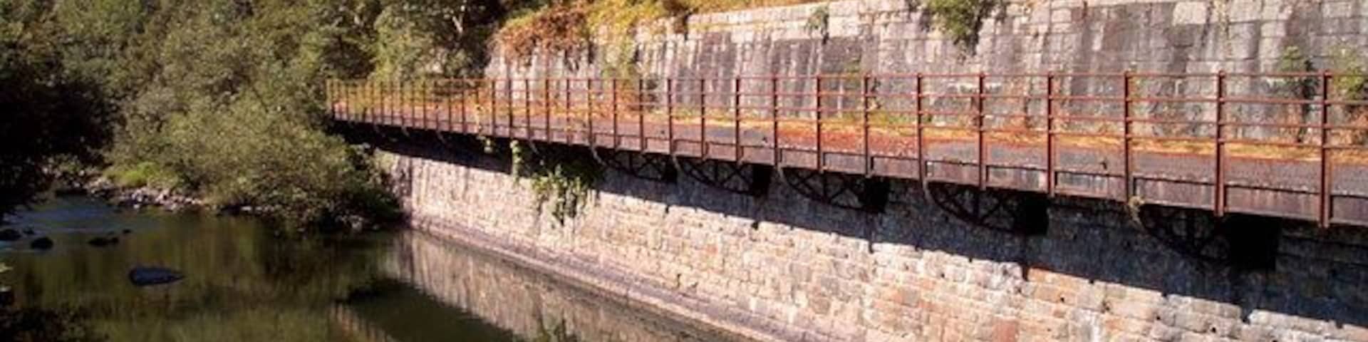Disused cantilevered mine railway/conveyor. This structure hangs over the river Taff and may have been a railway or conveyor belt
