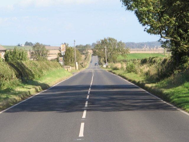 (The line of) Hadrian's Wall by the site of Milecastle 18, Data from Geograph: Description: The Wall itself lies under the Military Road (B6318). ICBM: 55.009685154362, -1.9236661389707 Location: 3 km from Harlow Hill, Northumberland, Great Britain.