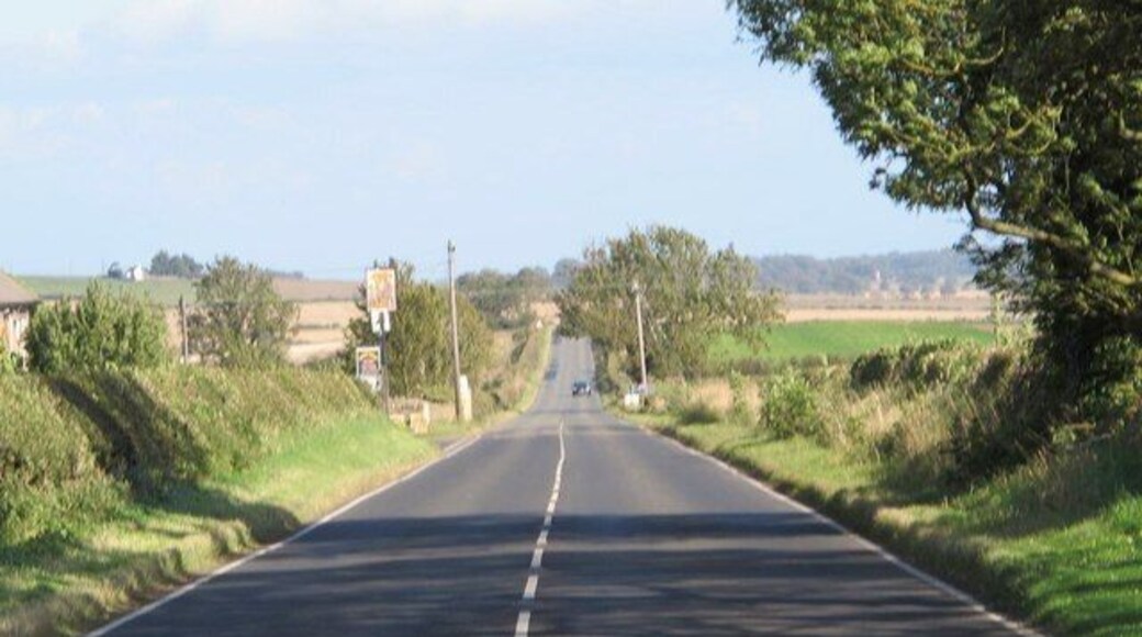 (The line of) Hadrian's Wall by the site of Milecastle 18, Data from Geograph: Description: The Wall itself lies under the Military Road (B6318). ICBM: 55.009685154362, -1.9236661389707 Location: 3 km from Harlow Hill, Northumberland, Great Britain.