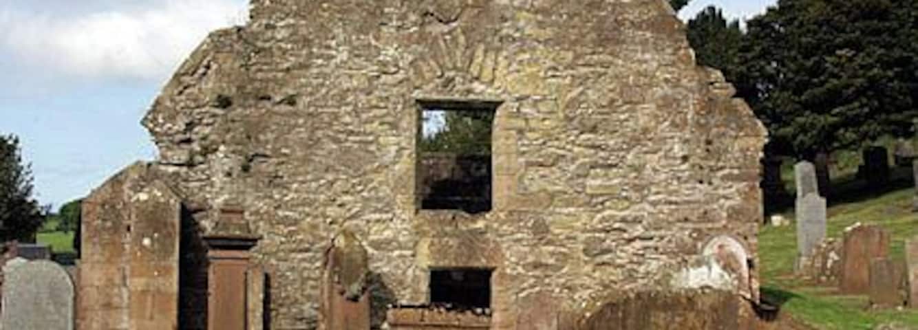 Old church and graveyard The east gable of the old church in Kirkoswald. The church dates back to 1244 and according to legend is the site where St Oswald fought a great battle in 634 A.D. and built a chapel in celebration of his victory. The churchyard contains some very interesting gravestones, including a memorial to Robert Burns' mother's people, and gravestones for the real people who inspired the main characters in Burns' poem 'Tam O' Shanter'.