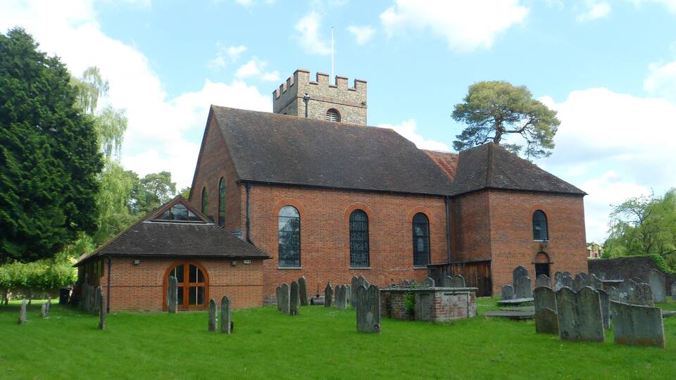 A church with a bell tower and a graveyard.