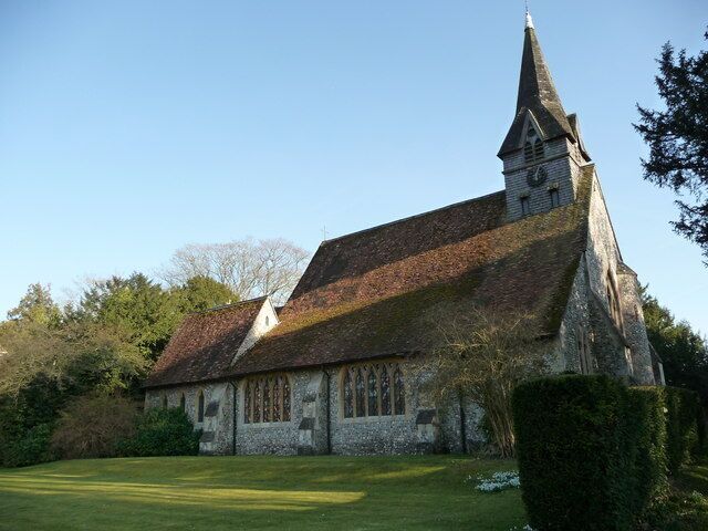 A church with a steeply pitched roof and a tall steeple.