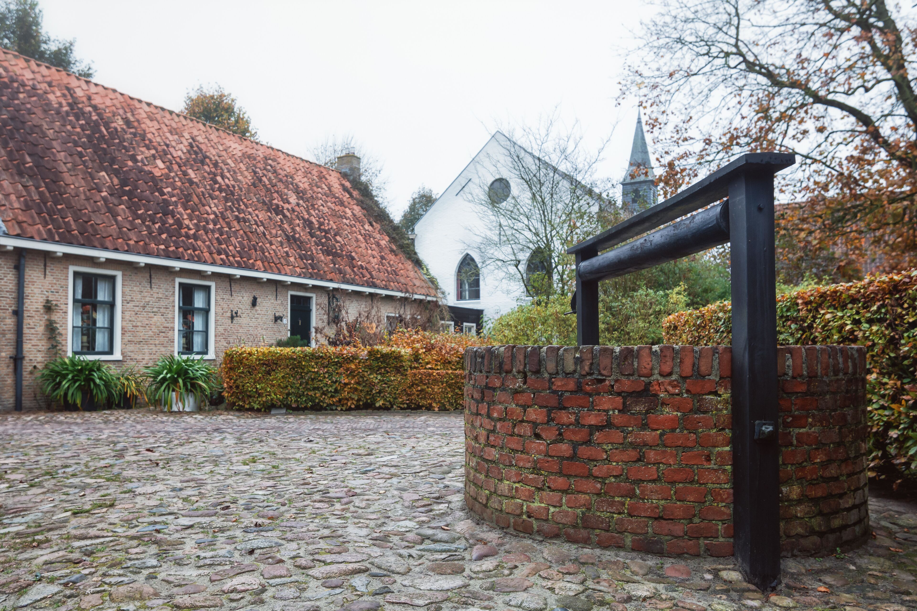Small house with well in Bourtange, a Dutch fortified village in the province of Groningen