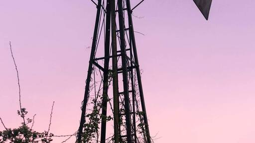 Village manor house The Grange located on the edge of long lawford. Disused wind powered water pump