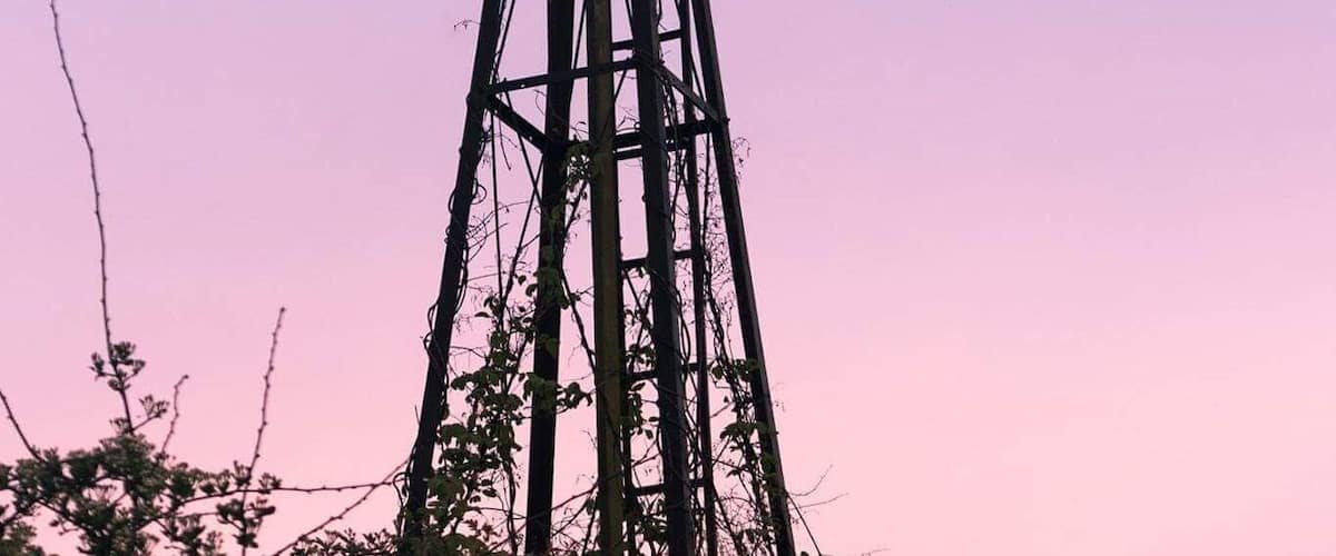 A windmill against a purple sky.