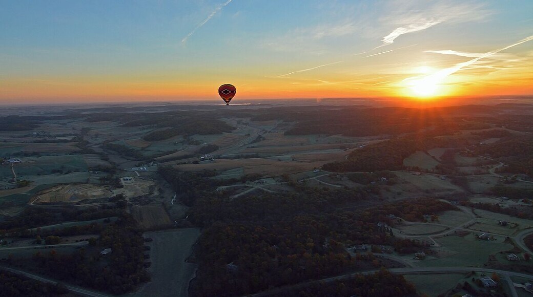 Taken from a second hot air balloon this shot shows a hot air balloon in the distance with a slight glow at sunrise. It is hard to stay calm when you are in a basket 4,000 feet up in the air.