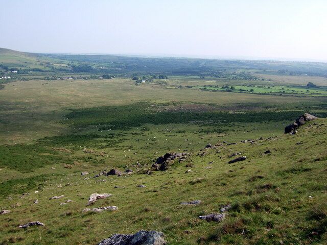 Cors Tewgyll Swampy moorland between the eastern slope of Carn Talfynydd and the dispersed settlement of Mynachlog-ddu, part of which can be seen here. There are two Tewgyll streams running down the valley here from the north (left).