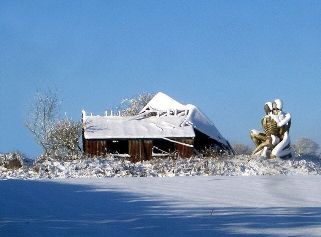 Scary Sculpture Here's a weird one. These spooky skeletons hold onto each other beside a wrecked shed. The site is an open field, nothing else around. Just a sense of desolation, which I guess is what the artist intended. I would love to know more.