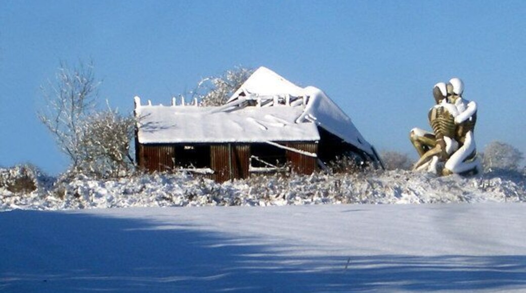 Scary Sculpture Here's a weird one. These spooky skeletons hold onto each other beside a wrecked shed. The site is an open field, nothing else around. Just a sense of desolation, which I guess is what the artist intended. I would love to know more.