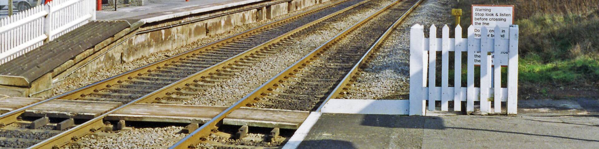 Gomshall station, eastbound platform 1993. View eastward, towards Redhill: ex-SE&CR Redhill - Guildford - Reading secondary main line. 'Gomshall & Shere' until 12/5/80, this station has staggered platforms withe westbound behind the camera. The North Downs are prominent in the background