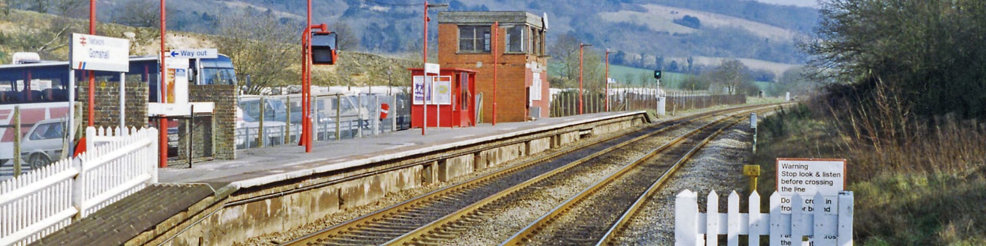 Gomshall station, eastbound platform 1993. View eastward, towards Redhill: ex-SE&CR Redhill - Guildford - Reading secondary main line. 'Gomshall & Shere' until 12/5/80, this station has staggered platforms withe westbound behind the camera. The North Downs are prominent in the background