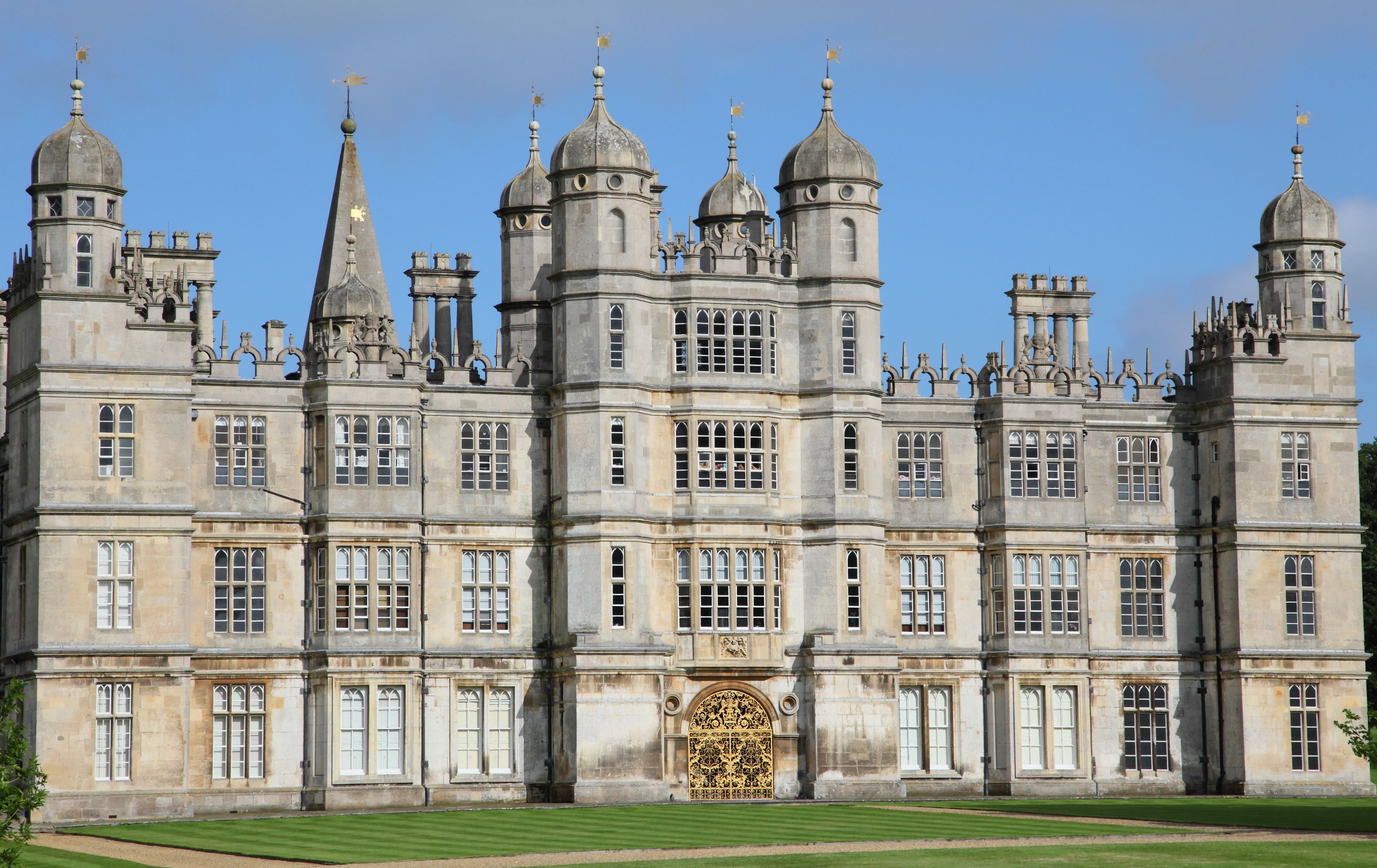 A large, historic building with multiple towers and a central entrance.