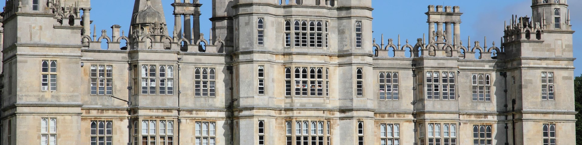 A large, historic building with multiple towers and a central entrance.