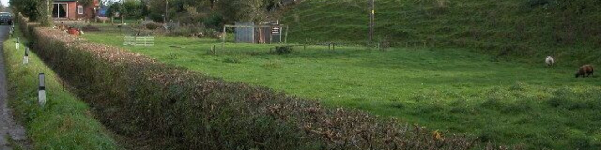Stanley House, Dymock. Just north of Dymock is Stanley House. On the right of the picture is an embankment though I am not sure if it was for a railway. The course of the old Gloucester to Ledbury line is just beyond the house.