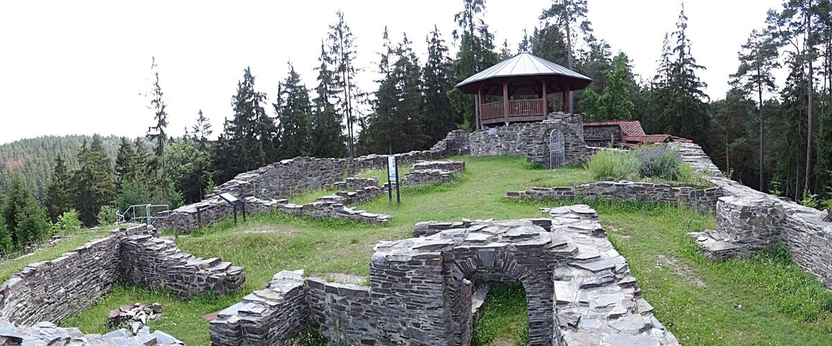 Antiguas ruinas de piedra con un pabellón de madera.