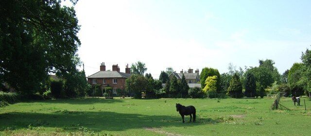 Tyrells End, Eversholt. A view across a paddock at Tyrells End towards some of the substantial houses that make up this part of Eversholt.