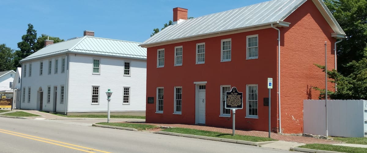 A historic red building with a white building next to it.