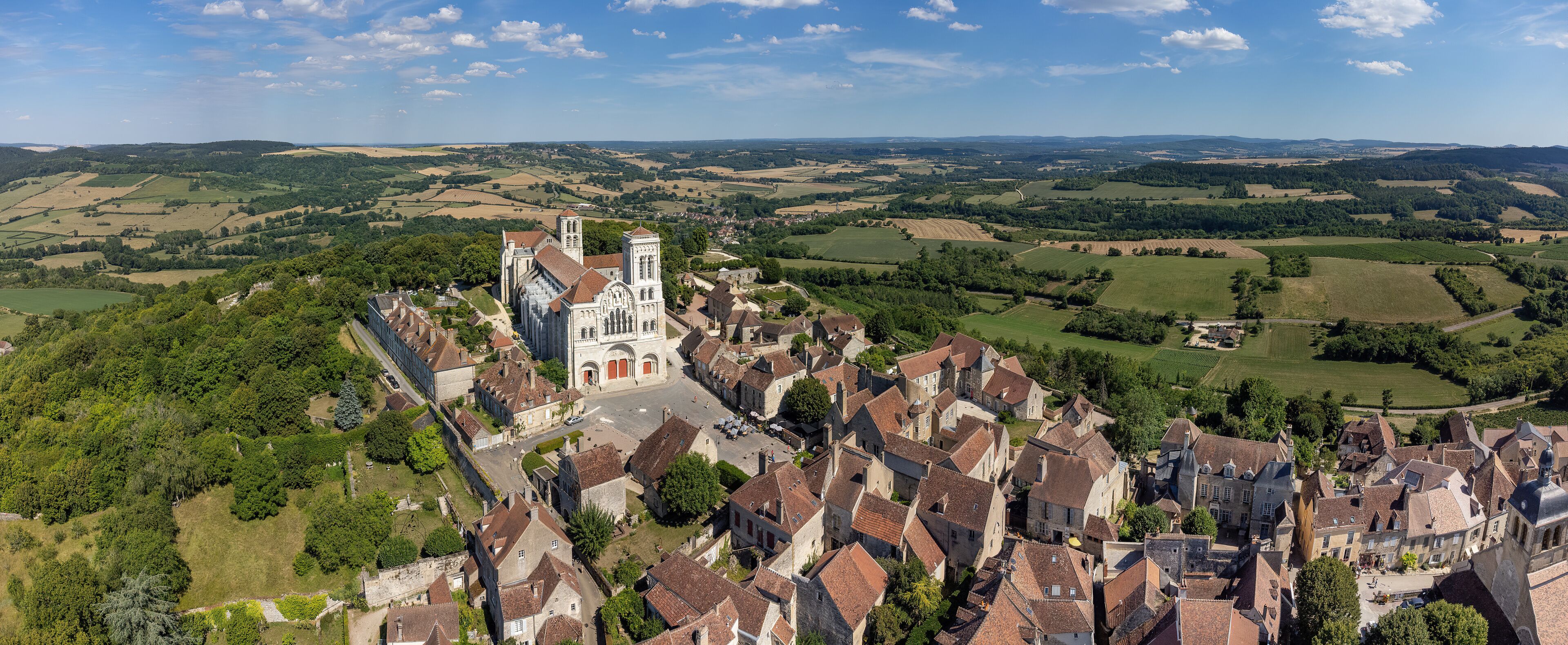 A historic town with a prominent church and rolling countryside.