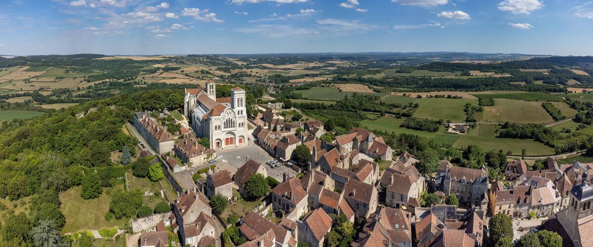 A historic town with a prominent church and rolling countryside.