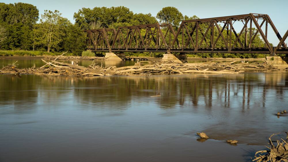 Iron through truss bridge crosses the Des Moines River from Ottumwa Iowa to Turkey Island. Train bridge built in 1911.