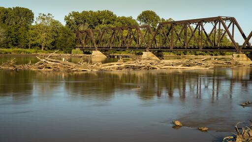 Iron through truss bridge crosses the Des Moines River from Ottumwa Iowa to Turkey Island. Train bridge built in 1911.