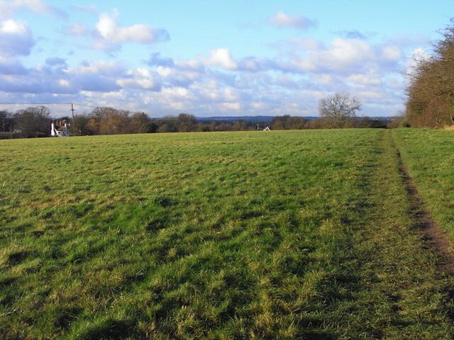 Pasture, Three Mile Cross A footpath follows the edge of the field before a slight descent to the village.