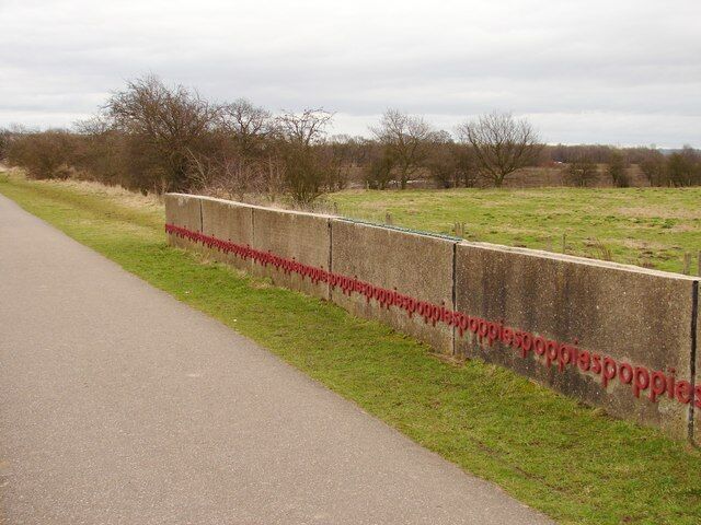 Poppies Artwork by Simon Cutts created from a section of runway from WW2 airfield at RAF Swinderby. The letters are cast from anodised aluminium, the same material from which many of the World War II planes would have been made. The reverse of the wall is an imprint of the earth beneath the Swinderby base.