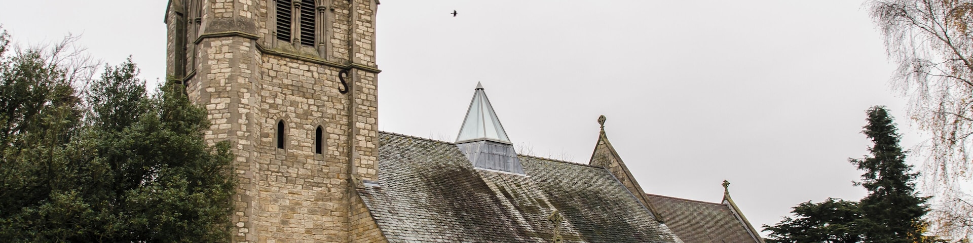 There has been a church on the site since the 13th century. By 1854 the church was in a dilapidated condition and was rebuilt in 1855 by Hussey, using much of the old materials. There was a nave with clerestory, north and south aisles, and also a spire on the tower roof. The lower stages of the tower still contain some mediaeval masonry. In 1916 there was a severe fire which left only the walls standing. Due to limited funds, only the chancel was given a permanent roof, the nave had a temporary roof which lasted nearly 80 years! The spire was never rebuilt, and the aisle arcades replaced with brick and concrete ones. The church was re-ordered in 1992 when the nave and aisle roofs, internal columns and pews were removed, and a new roof which spans the whole width of the church containing a glass lantern skylight. Services are now held in the nave part of the church, with the chancel being used for the creche and for more intimate services. There is a fine east window by Edward Payne. The church now has a Kitchen, toilet and Wi-fi.