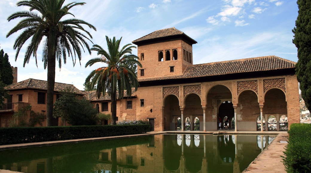 The name Alhambra comes from an Arabic root which means red or crimson castle, perhaps due to the hue of the towers and walls that surround the entire hill of La Sabica which by starlight is silver but by sunlight is transformed into gold. But there is another more poetic version, evoked by the Moslem analysts who speak of the construction of the Alhambra fortress by the light of torches, the reflections of which gave the walls their particular coloration. Created originally for military purposes, the Alhambra was an alcazaba (fortress), an alcázar (palace) and a small medina (city), all in one.