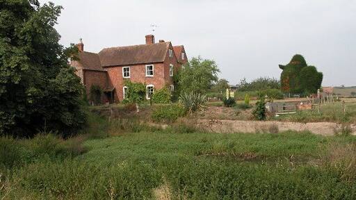 Wigwood Farm, Tirley. Farmhouse overlooking an overgrown pond.