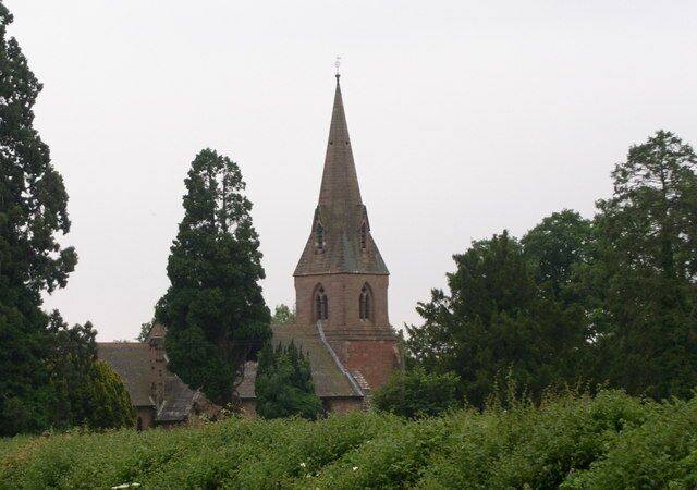 West tower and spire of St Laurence's parish church, Wichenford, Worcestershire, seen through trees