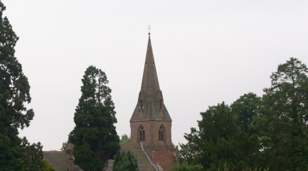 West tower and spire of St Laurence's parish church, Wichenford, Worcestershire, seen through trees