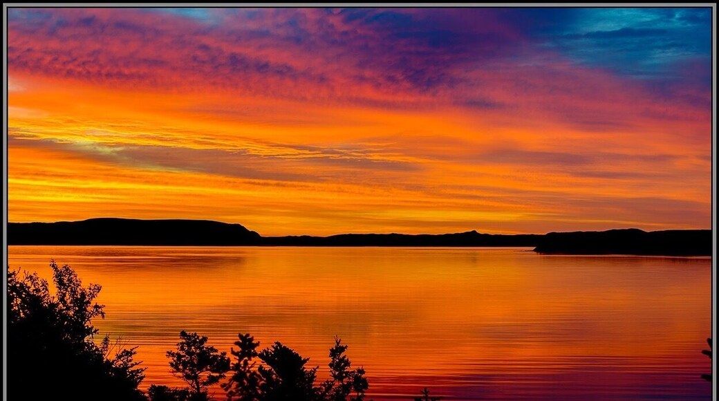 I got this beautiful sunrise from the back porch of our cabin while staying at Captain Cook's Cottages in York Harbour, NL. This shot was taken overseeing The Bay of Islands. I loved our stay at Captain Cook's Cottages and intend on going back. The owners are wonderful hosts and I have much more to see there.