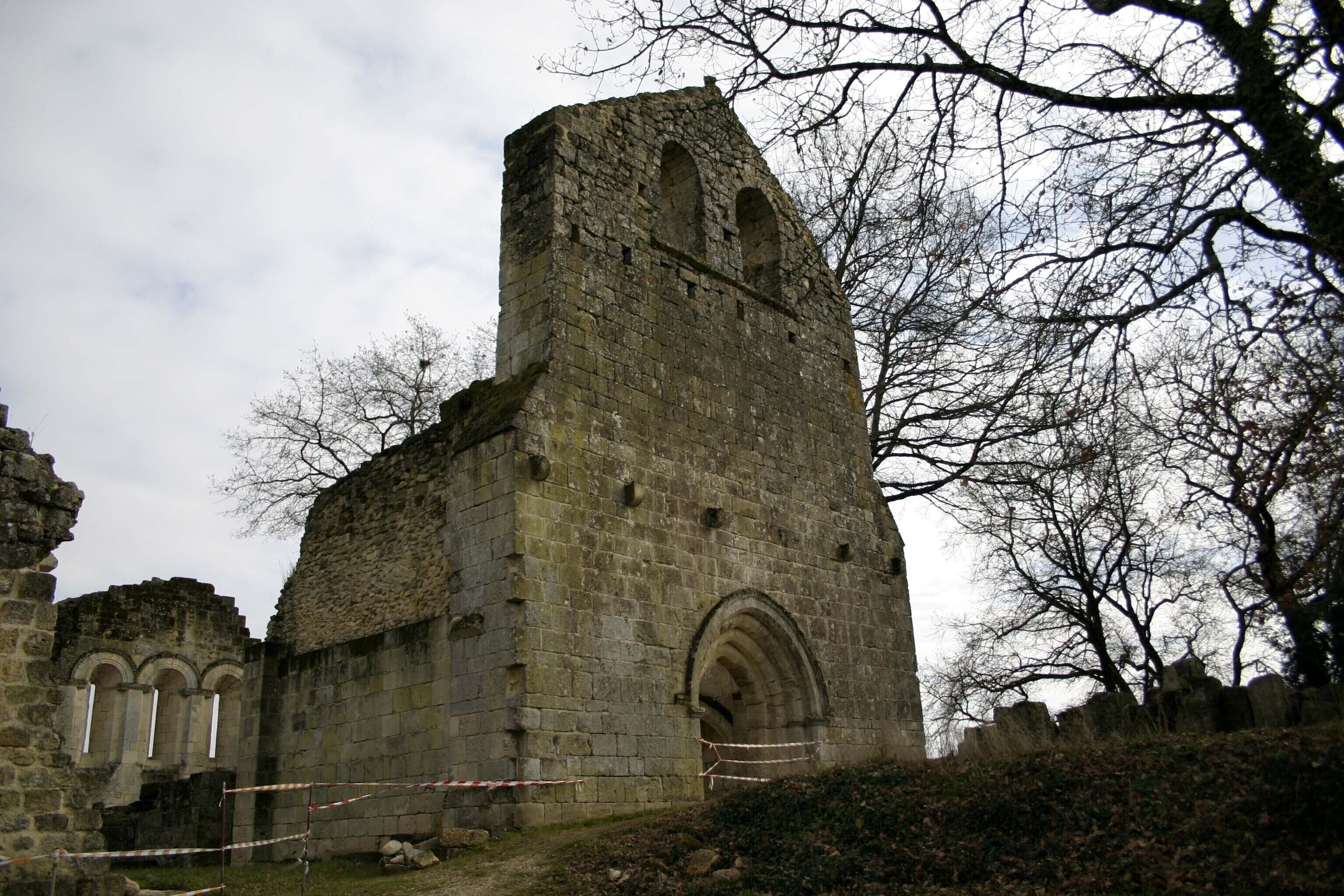An old stone church with arched windows and a tall tower.