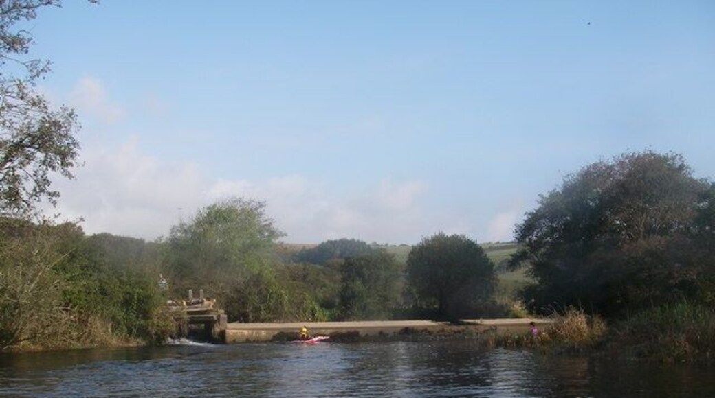 Aveton Gifford Weir The weir at the tidal limit of the Avon estuary near Aveton Gifford. The river control hatch is visible on the left, but less visible from this viewpoint is the unusual salmon pass. It runs parallel to the weir face in the centre of the weir.