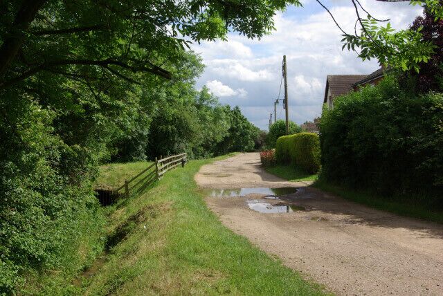 Wood Road, Harrold Unmade road on the northern edge of the village which peters out into a bridleway. Seen here looking towards the village.