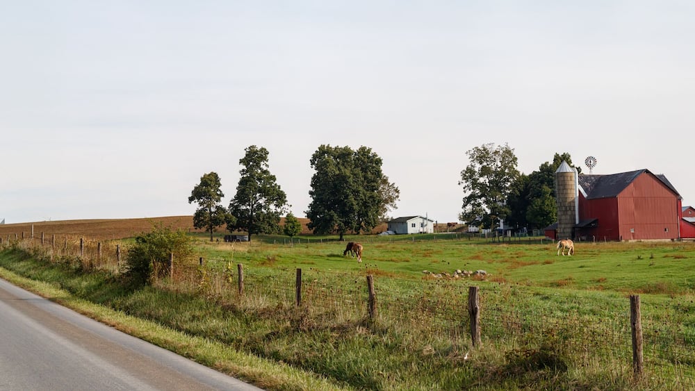 Amish farm with a red barn beside a country road | Kansas Road - Holmes County, Ohio