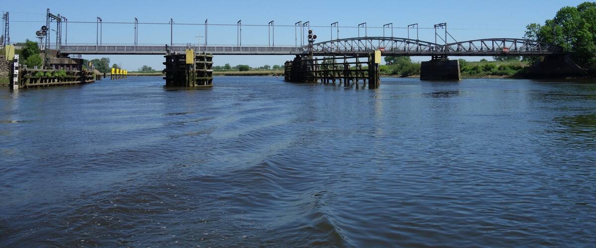 A bridge over a river with a clear sky.