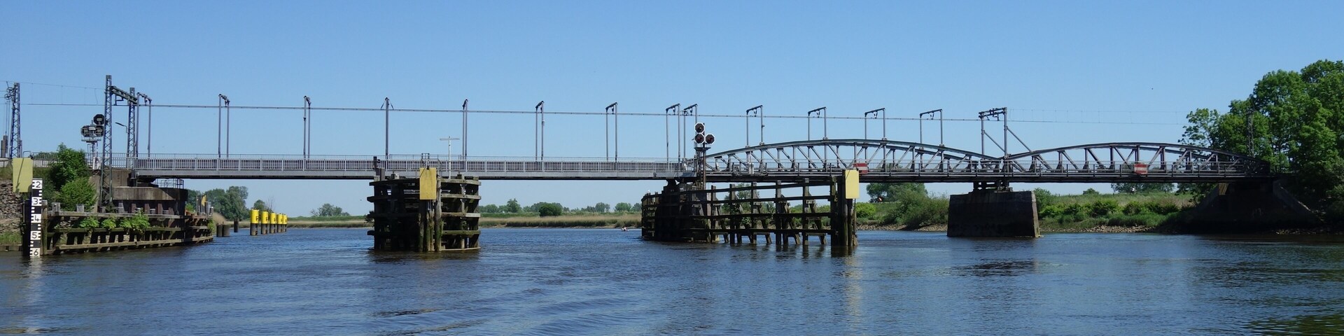 A bridge over a river with a clear sky.