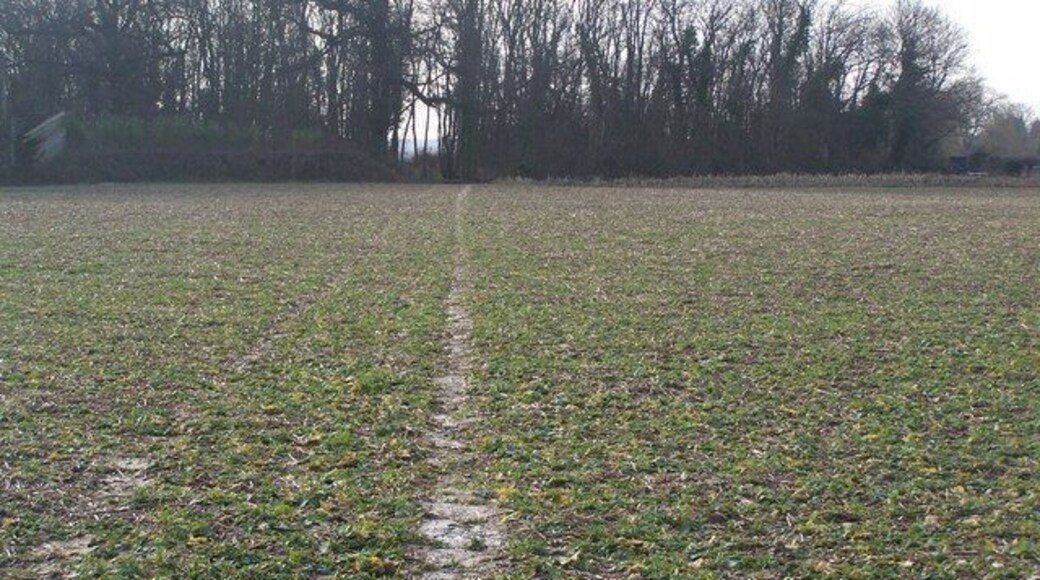 Footpath to Madam Wood Path from Downs Road,near Northfleet Green Farm leads through field and woodland to New Barn Road.
