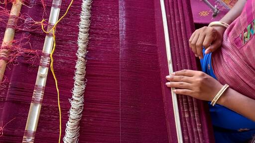 Handloom weaver in India working in her loom.
