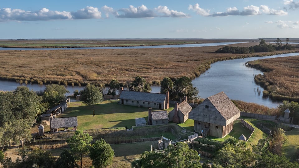A historic site with buildings and a river.