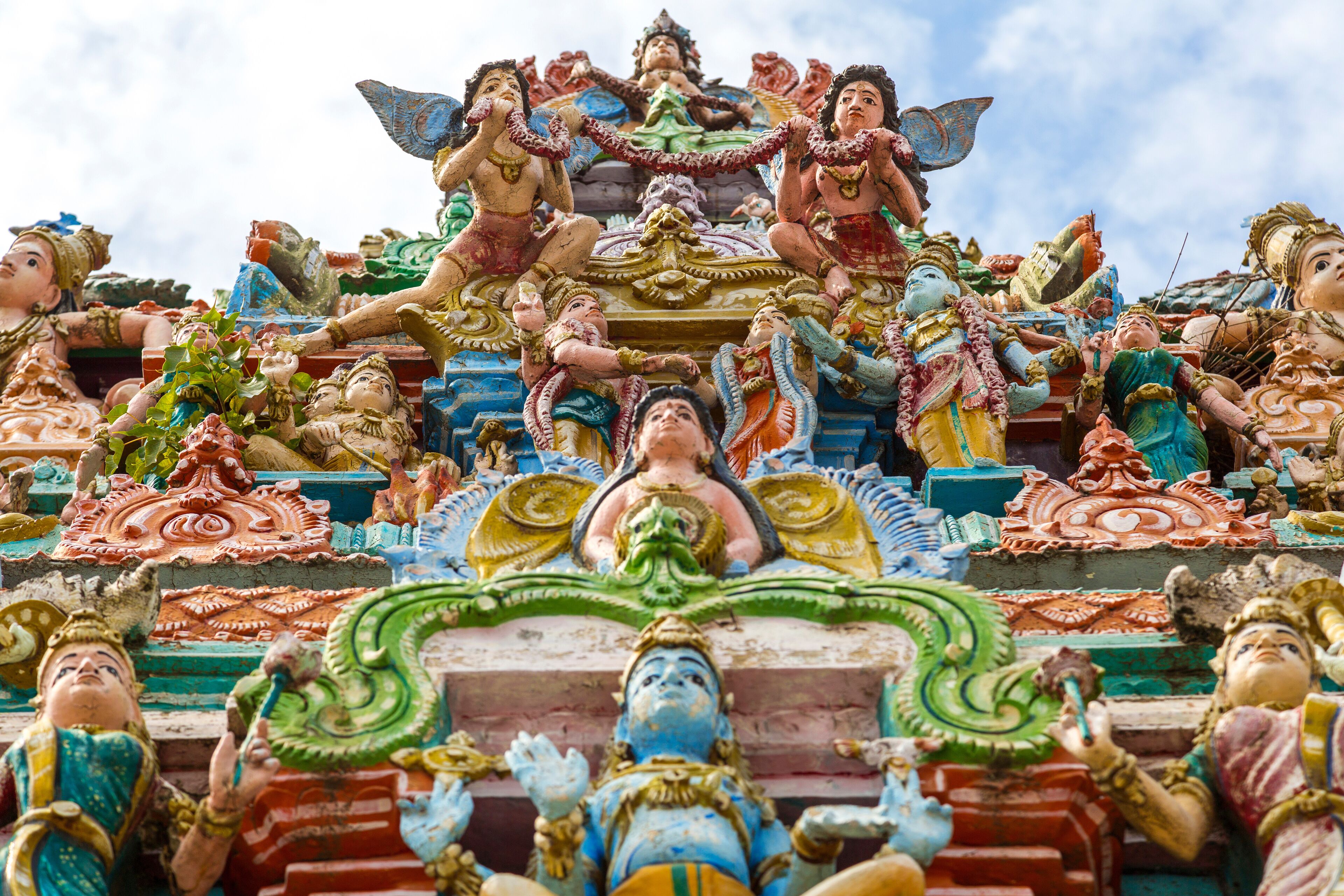 A colorful temple with intricate carvings and statues of deities.